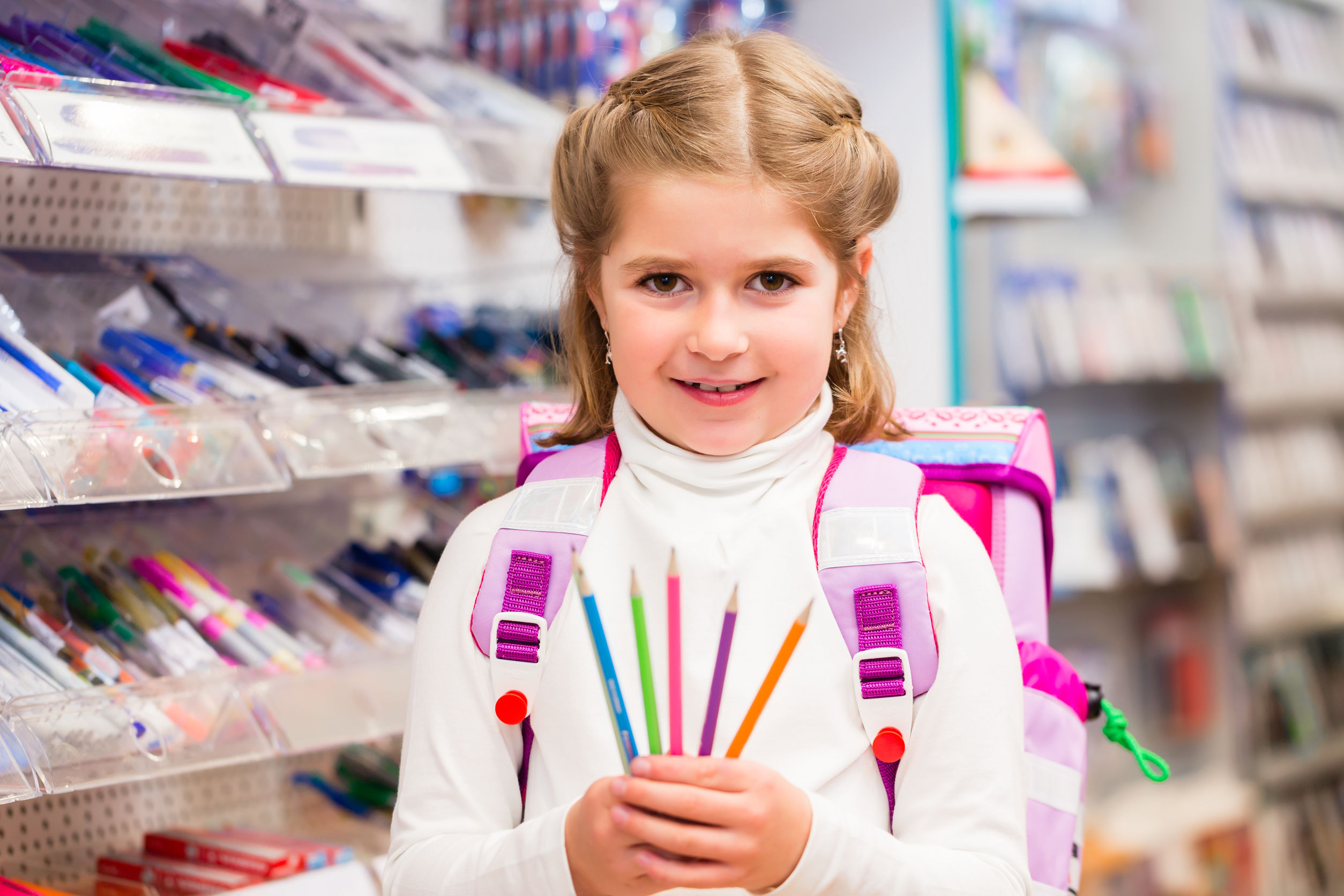 Girl holding school supplies