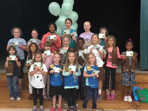 Girls receiving their well-earned patches.
